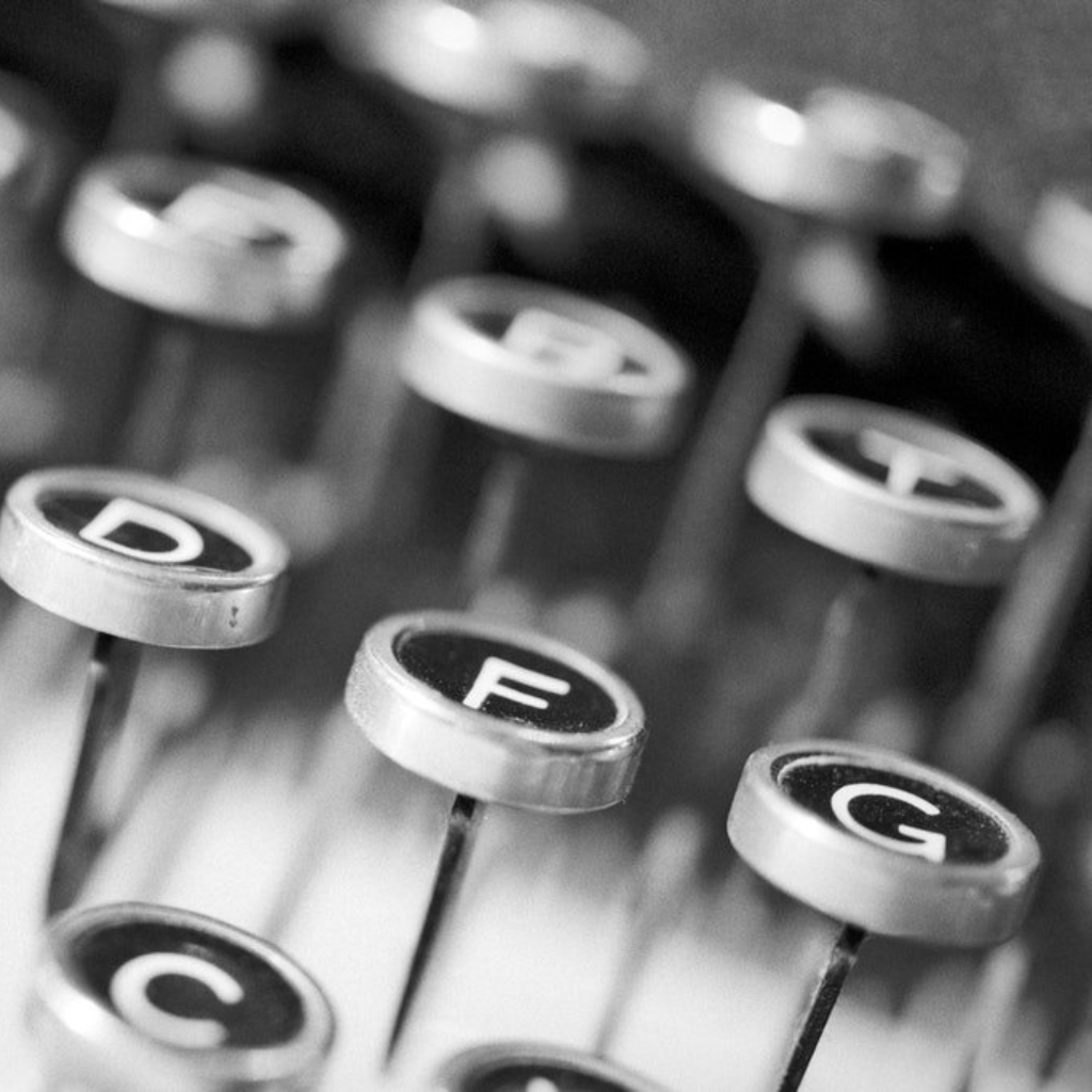 a black and white photo of typewriter keys