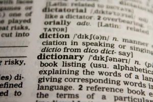 Close-up of black and white page of dictionary on the words "diction" and "dictionary"
