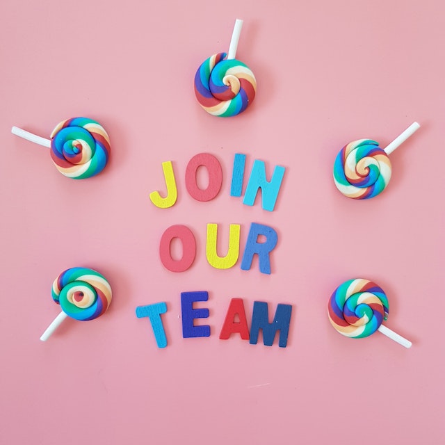"Join our team" on a pink background with rainbow lollipops.